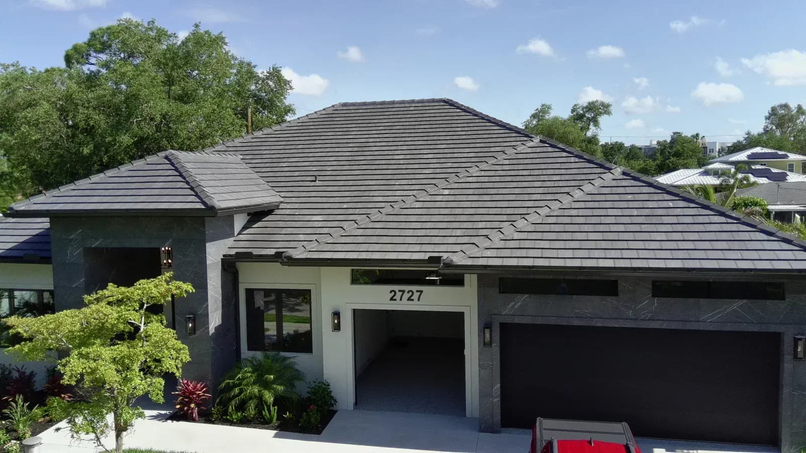 Aerial view of a new-construction home with a hip tile roof
